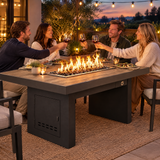 Couples toasting at a dinner party around a Top Fires Alameda 72-inch composite wood gas fire table with a Bellevue tabletop and Black base
