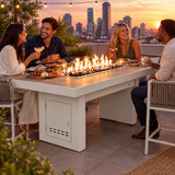 Friends enjoying tapas and cocktails on a rooftop terrace around a Top Fires Alameda 72-inch composite wood gas fire table with a Bellevue tabletop and White base