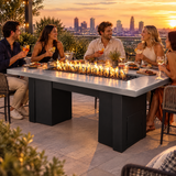 Friends enjoying tapas and cocktails on a rooftop terrace around a Top Fires Alameda 72-inch GFRC gas fire table with a Metallic Silver tabletop and Black base