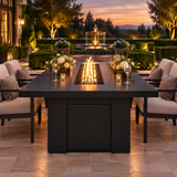 Top Fires Alameda 72-inch GFRC gas fire table with a Smooth Black tabletop and Black base on a grand estate terrace with fountain at dusk