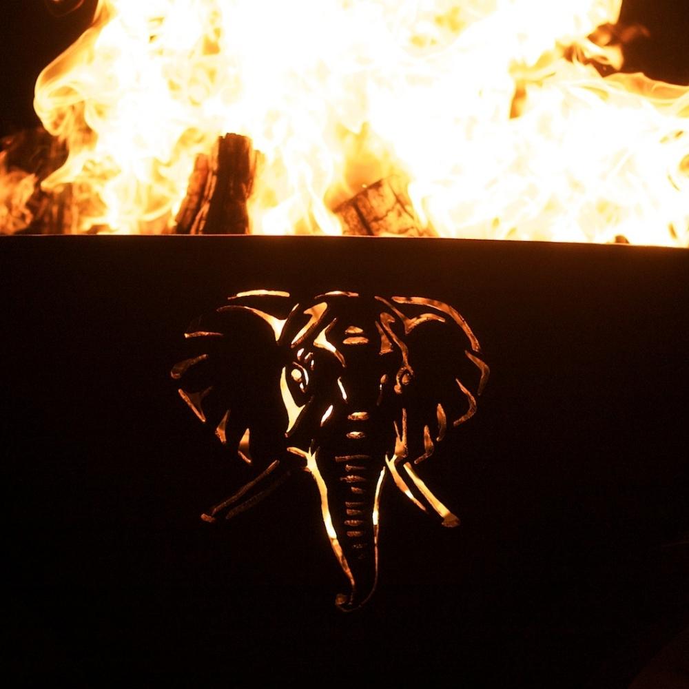Elephant Design of Fire Pit Art Africa's Big Five With Burning Logs - angle view