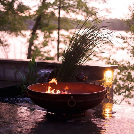 Fire Pit Art Emperor 37-Inch Handcrafted Carbon Steel Gas Fire Pit in the Rain