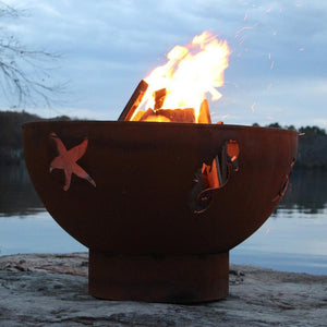Fire Pit Art Sea Creatures - 36" Handcrafted Carbon Steel Gas Fire Pit Lit Up Beside A Lake