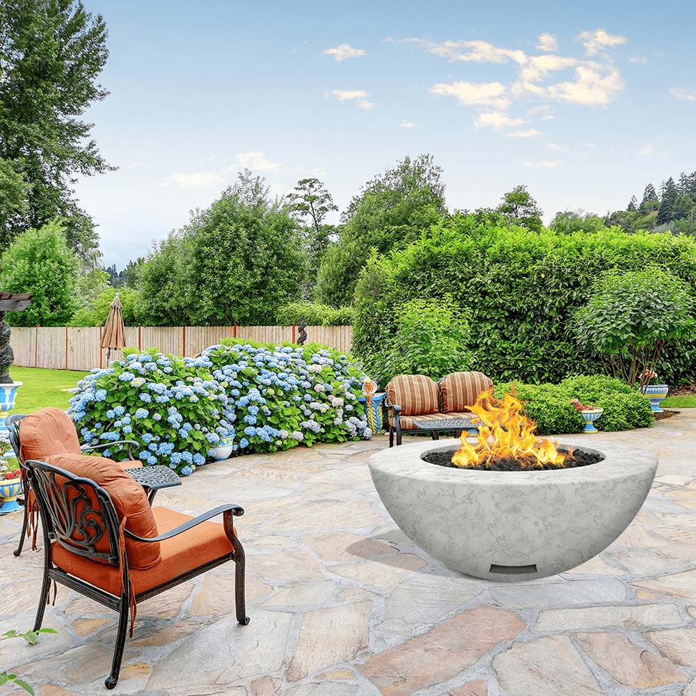 modern blaze round arctic fire bowl with textured surface in a lush garden - installation view