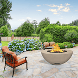 modern blaze round bone fire bowl with smooth surface in a lush garden - angle view