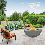 modern blaze round slate fire bowl with smooth surface in a lush garden - angle view