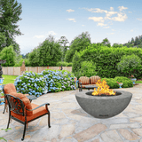 modern blaze round slate fire bowl with textured surface in a lush garden - angle view