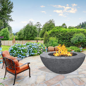 modern blaze round coal fire bowl with textured surface in a lush garden
