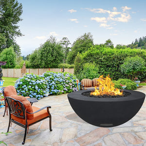 modern blaze round raven fire bowl with smooth surface in a lush garden