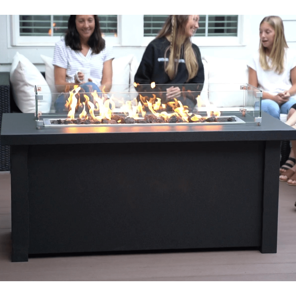 gathering around the Modern Blaze 54-Inch Linear Fire Pit Table