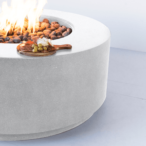 Modern Blaze Oblica Shasta Snow Round Fire Pit with appetizers on the side