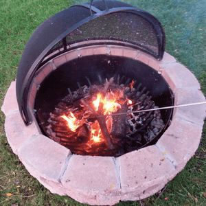 Modern Blaze Round Pivot Steel Screen on Fire Pit catching ashes and embers