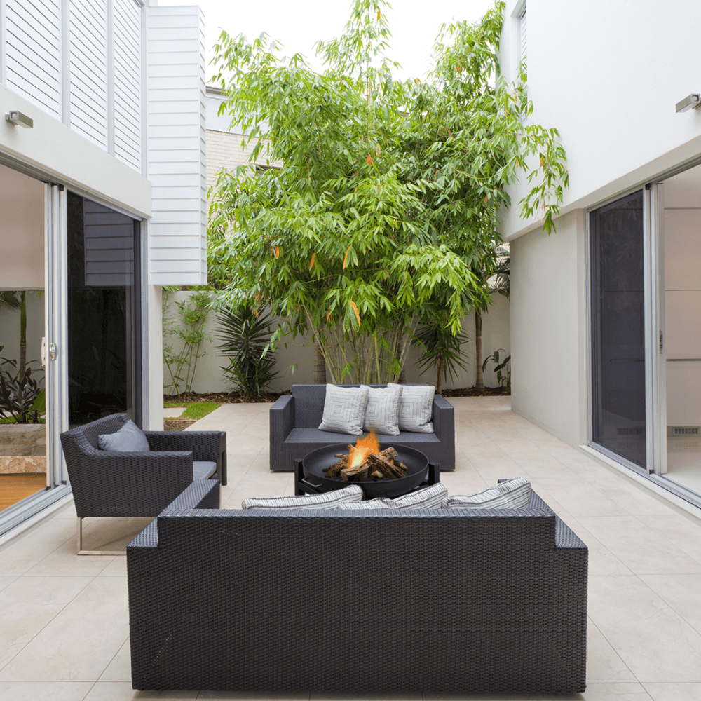 modern blaze round steel fire pit in a cozy patio setting