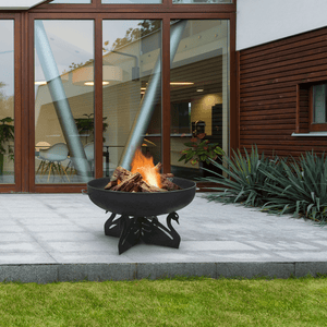 modern blaze round swan base steel fire pit in a contemporary outdoor space