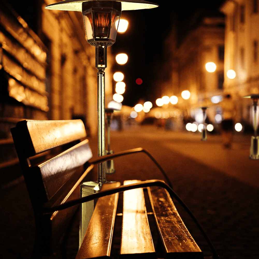 RADtec Real Flame Stainless Steel Patio Heater beside outdoor bench - room setting