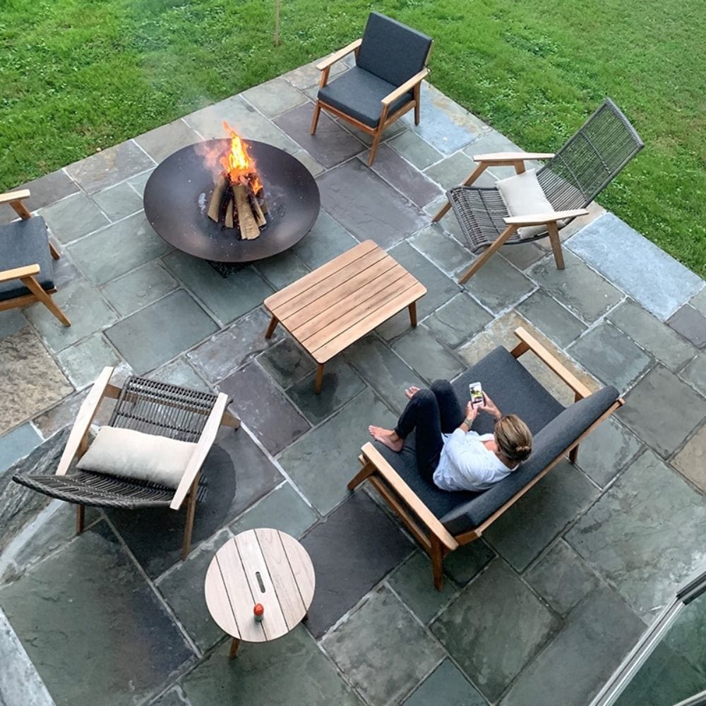 a cozy gathering spot outdoors with the Seasons Fire Pits Concave Round Fire Pit