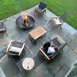 a cozy gathering spot outdoors with the Seasons Fire Pits Concave Round Fire Pit