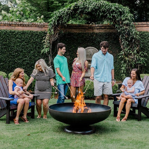 Seasons Fire Pits Vulcan Round Steel Fire Pit with Families Roasting Smores