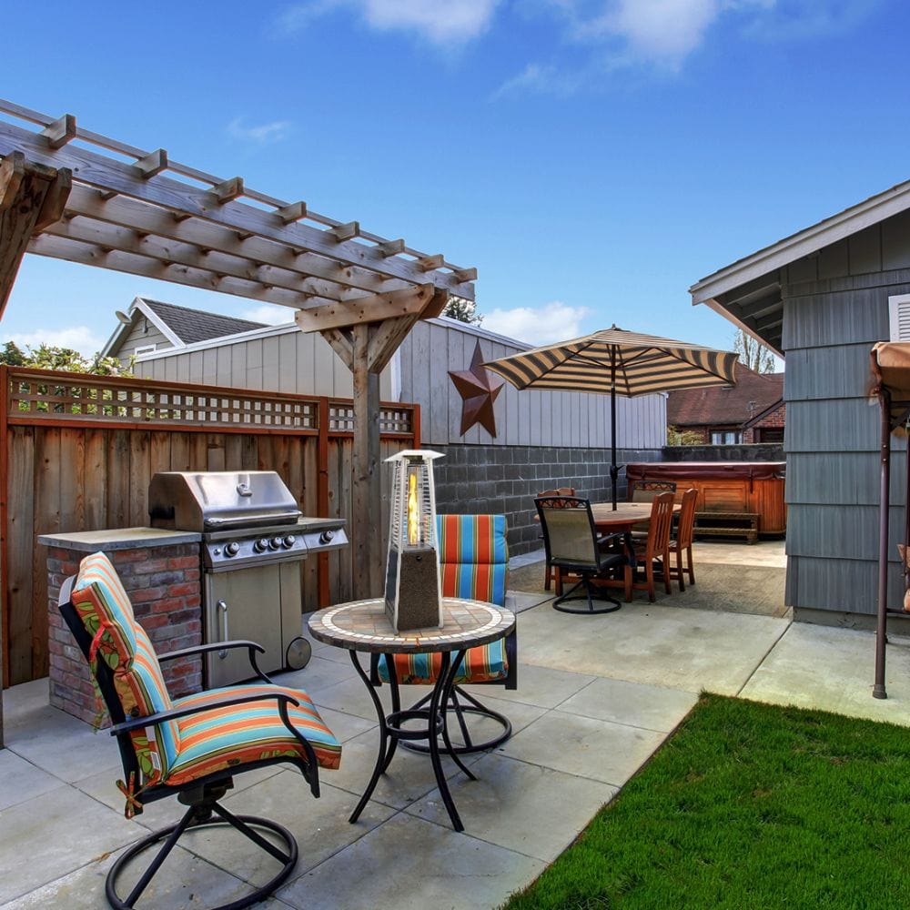 SUNHEAT Square Golden Hammered Tabletop Heater on an outdoor dining table