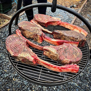 grilling tomahawk on the cowboy cauldron fire pit grill