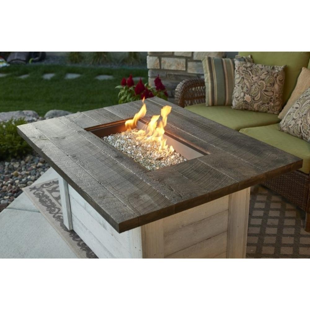 The Outdoor GreatRoom Company Alcott 48&quot; Rectangular Gas Fire Pit Table in a Patio