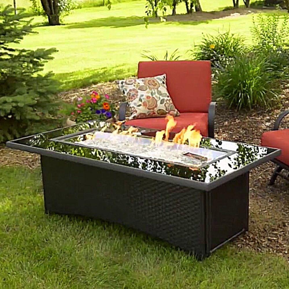 The Outdoor GreatRoom Company Balsam Montego 59&quot; Fire Pit Table in Garden setting