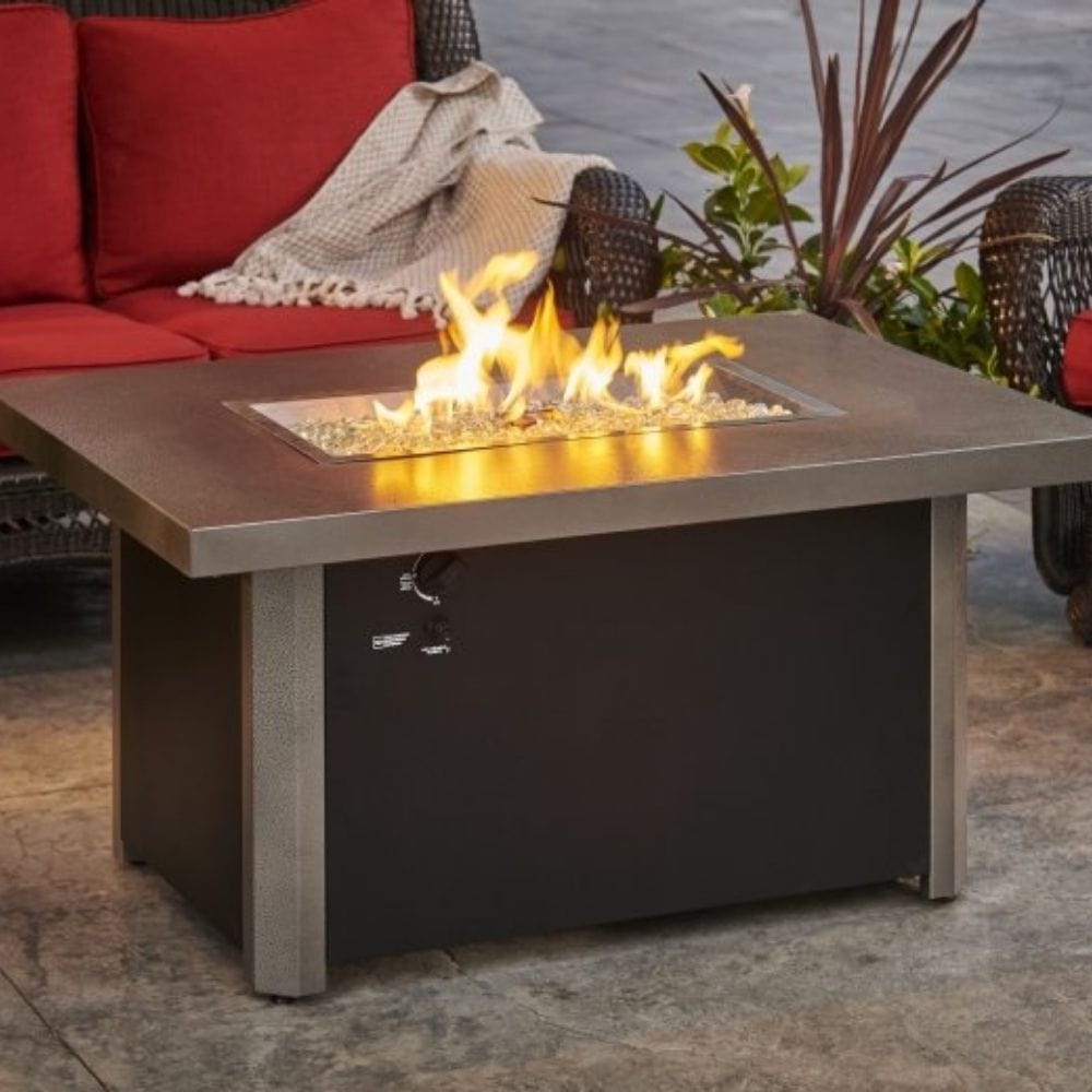 The Outdoor GreatRoom Company Caden 44&quot; Rectangular Fire Pit Table beside couches