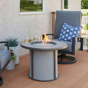 The Outdoor GreatRoom Company Stonefire Gray 31-inch Round Gas Fire Pit Table in patio