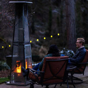 Timber Stoves Big Timber Elite Stainless Steel Pellet Patio Heater in the backyard at night