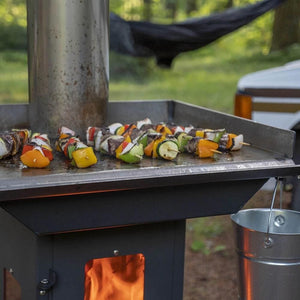 grilling skewers on the timber stove griddle