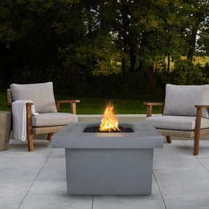 Gray Fire Pit Table with Chairs and View of Trees